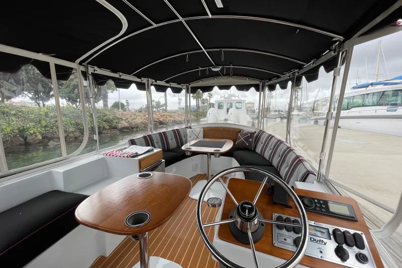 Slide: The Image of Interior of 2020 Duffy Snug Harbor 18 boat with seating and steering console. - 8