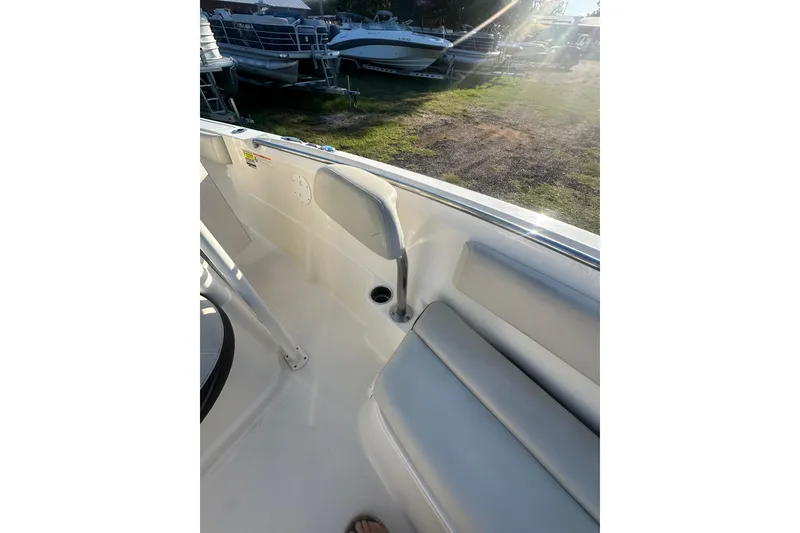 Slide: The Image of 2023 Sailfish 220 CC boat interior with seating and sunlight. - 11