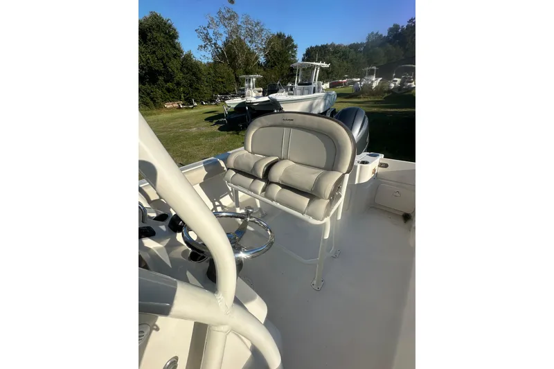 Slide: The Image of 2023 Sailfish 220 CC boat interior with cushioned seating and steering wheel. - 15