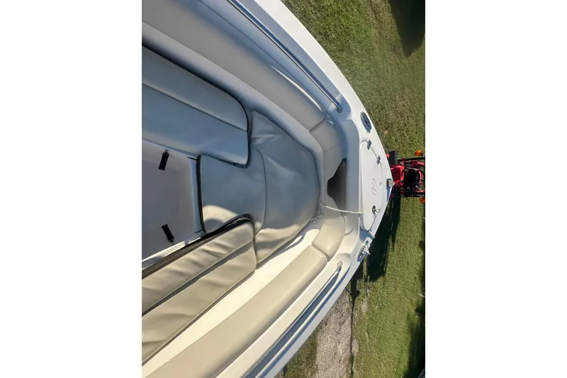 Slide: The Image of 2023 Sailfish 220 CC boat interior with cushioned seating and sleek design. - 16
