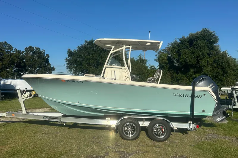 Slide: The Image of 2023 Sailfish 220 CC boat on trailer, side view, outdoors. - 2