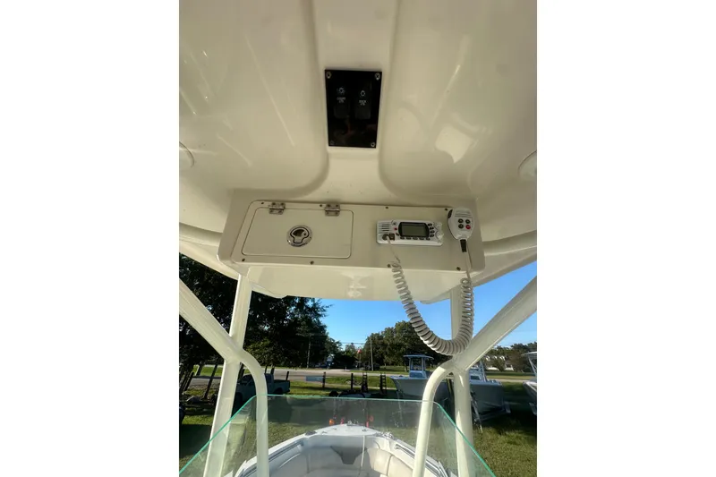 Slide: The Image of 2023 Sailfish 220 CC boat console with radio and storage compartment. - 26