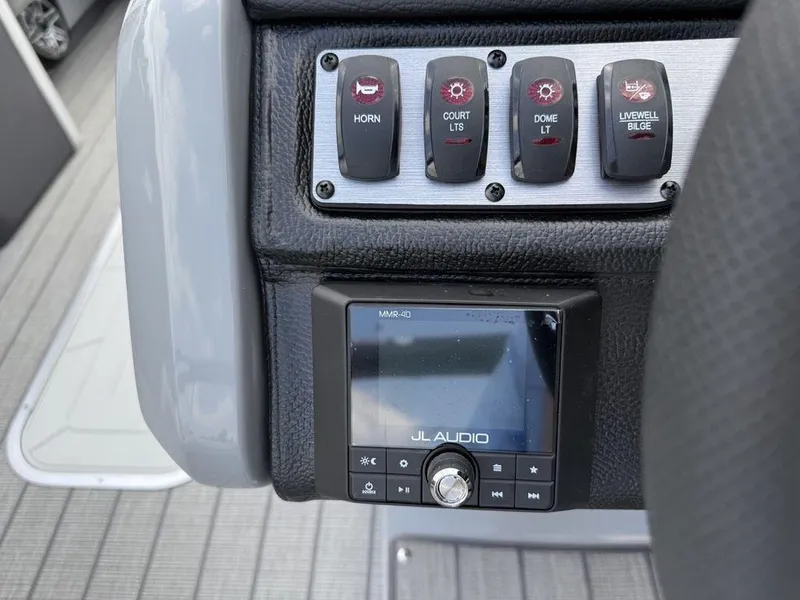 Slide: The Image of Control panel of 2025 Godfrey Monaco 235 SFL with JL Audio system and switches. - 11