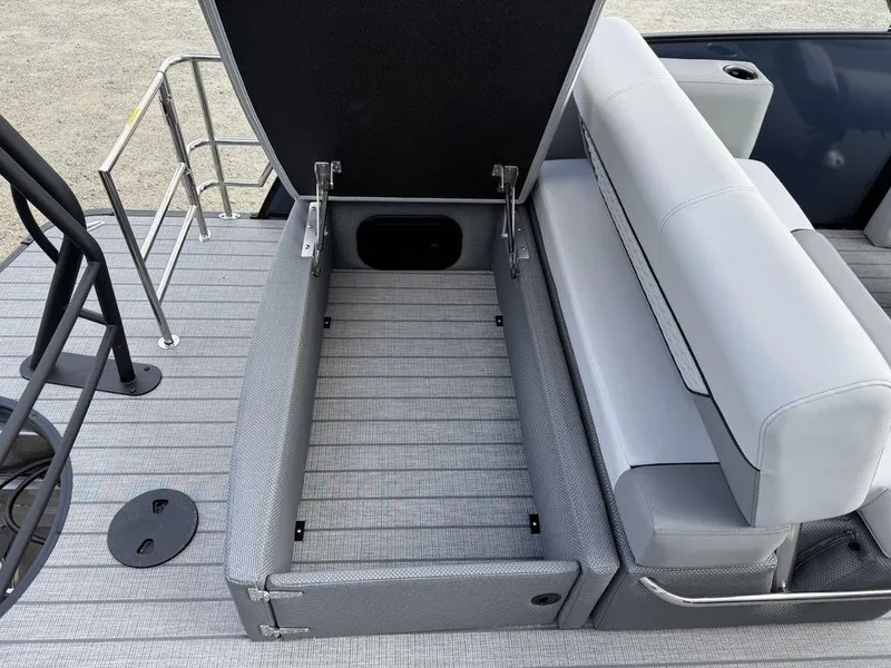 Slide: The Image of 2025 Godfrey Monaco 235 SFL boat with open storage compartment and sleek seating. - 26