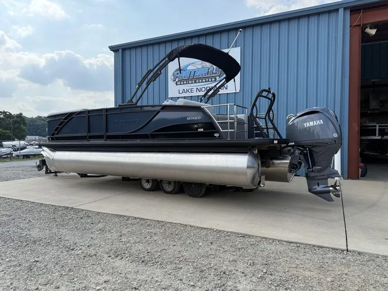 Slide: The Image of 2025 Godfrey Monaco 235 SFL pontoon boat with Yamaha motor at a marina. - 6