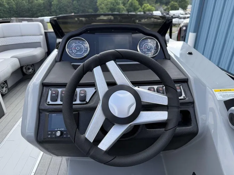 Slide: The Image of Steering console of 2025 Godfrey Monaco 235 SFL iMPACT pontoon boat, featuring modern controls. - 8