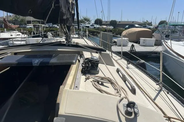 Slide: The Image of 1977 Islander 36 sailboat docked at marina, showing deck and rigging details. - 12