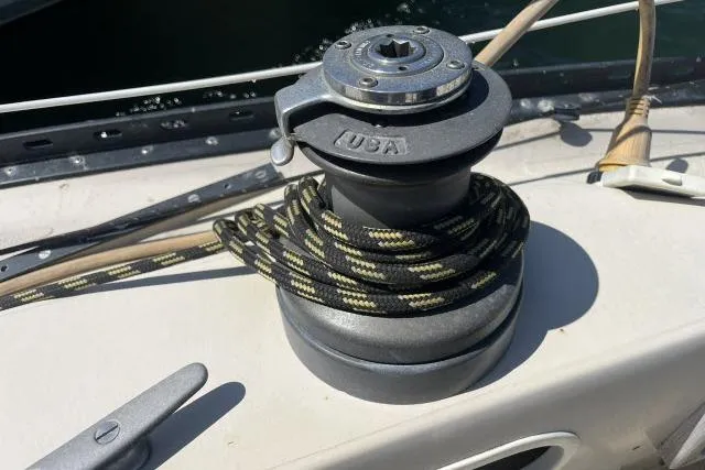 Slide: The Image of Winch on 1977 Islander 36 sailboat deck with coiled rope. - 15