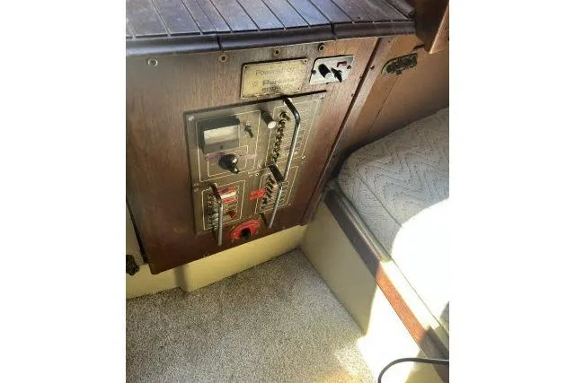 Slide: The Image of Control panel of a 1977 Islander 36 sailboat with wooden finish and seating area. - 5