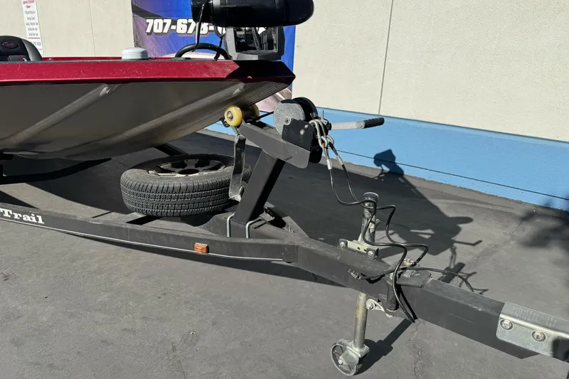 Slide: The Image of 2016 Ranger RT178 boat trailer with winch and spare tire on pavement. - 11