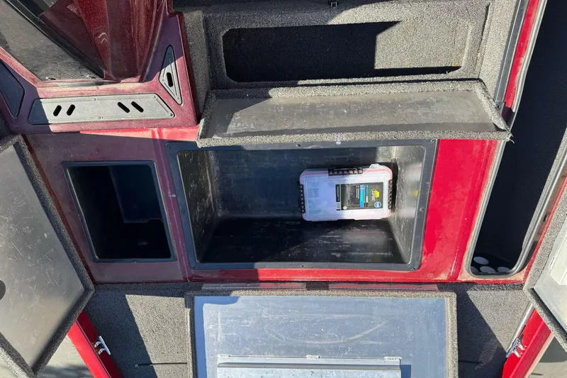 Slide: The Image of 2016 Ranger RT178 boat storage compartments with tackle box, red and black interior. - 17