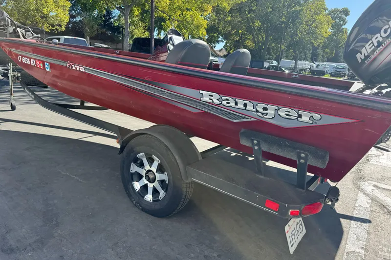 Slide: The Image of 2016 Ranger RT178 boat on trailer, red color, parked outdoors. - 19