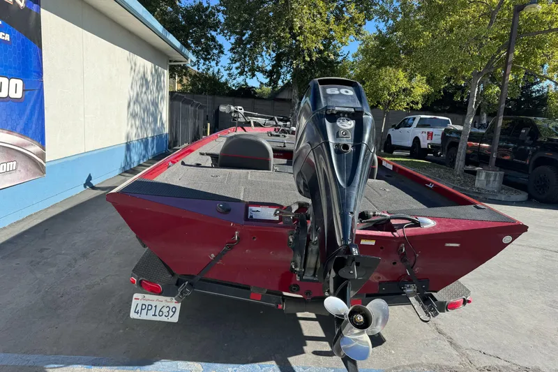 Slide: The Image of 2016 Ranger RT178 boat with outboard motor, parked outdoors on a sunny day. - 3