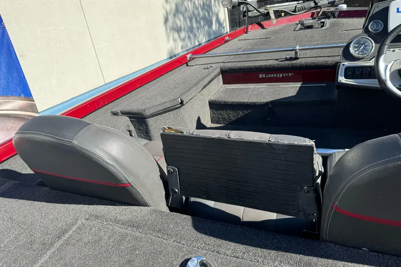 Slide: The Image of 2016 Ranger RT178 boat interior with seating and dashboard, featuring red and black accents. - 8