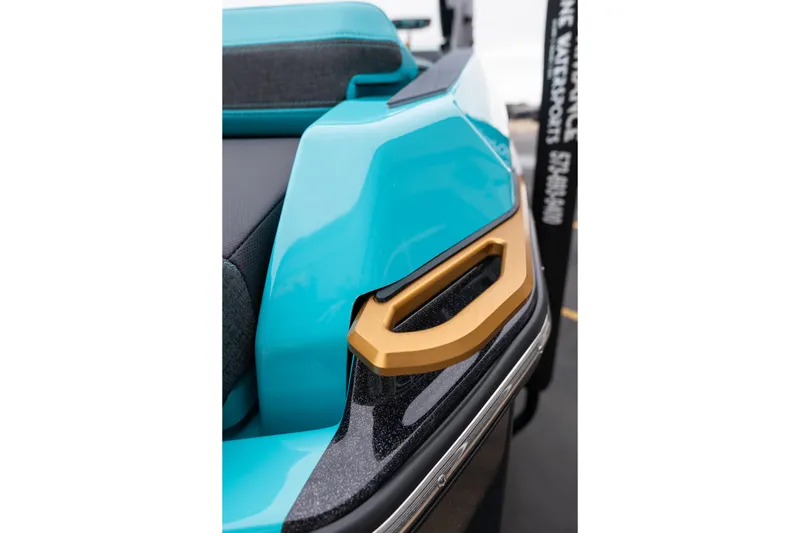 Slide: The Image of 2026 MasterCraft X24 boat detail with turquoise and gold accents. - 10