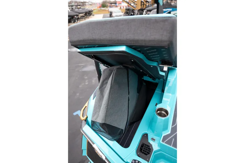 Slide: The Image of 2026 MasterCraft X24 boat storage compartment with open lid, showcasing interior features. - 13
