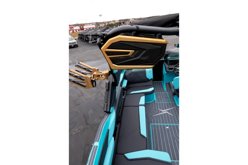Slide: The Image of 2026 MasterCraft X24 boat interior with turquoise and black seating, gold accents, and sleek design. - 14