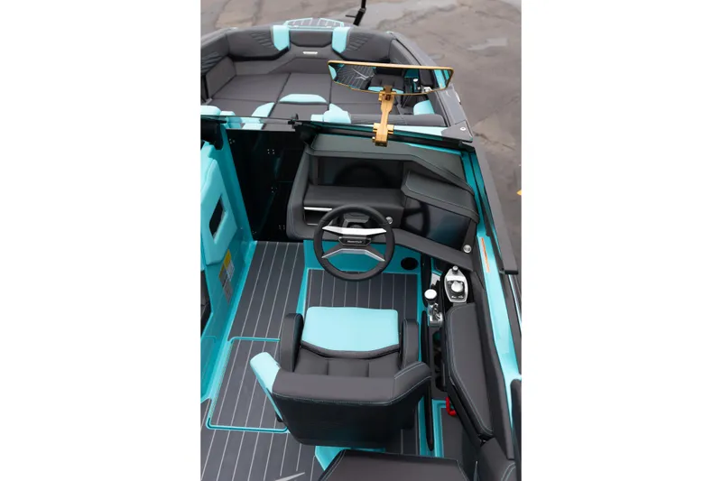 Slide: The Image of 2026 MasterCraft X24 boat interior with modern steering and seating in turquoise and black. - 18