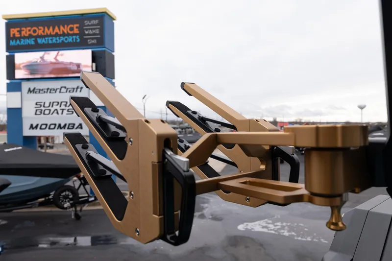 Slide: The Image of Golden wakeboard rack on 2026 MasterCraft X24 at marine dealership. - 19