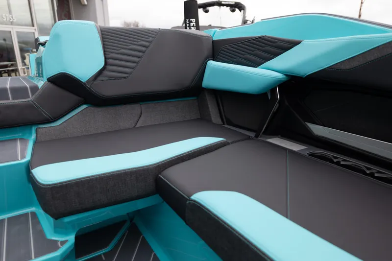 Slide: The Image of 2026 MasterCraft X24 boat interior with sleek turquoise and black seating design. - 27