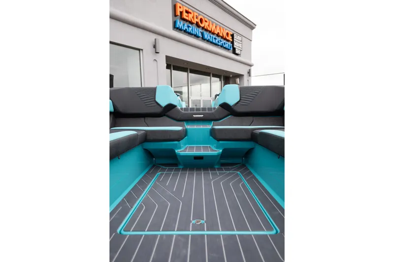 Slide: The Image of 2026 MasterCraft X24 boat interior with teal and black seating at Performance Marine Watersports. - 29