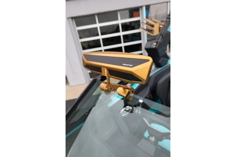 Slide: The Image of 2026 MasterCraft X24 boat with a sleek gold rearview mirror. - 30