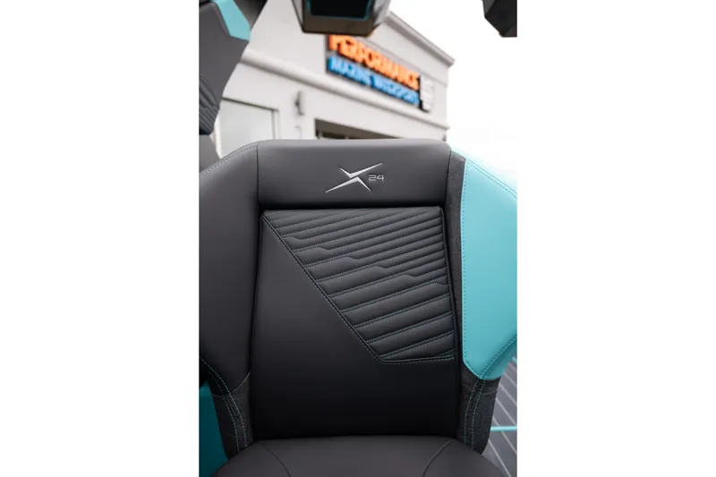 Slide: The Image of 2026 MasterCraft X24 boat seat with sleek black and teal design. - 32