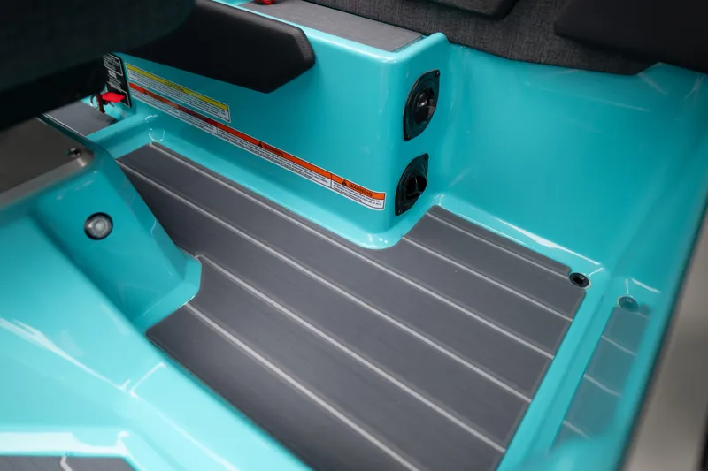Slide: The Image of 2026 MasterCraft X24 interior with teal accents and gray flooring. - 36