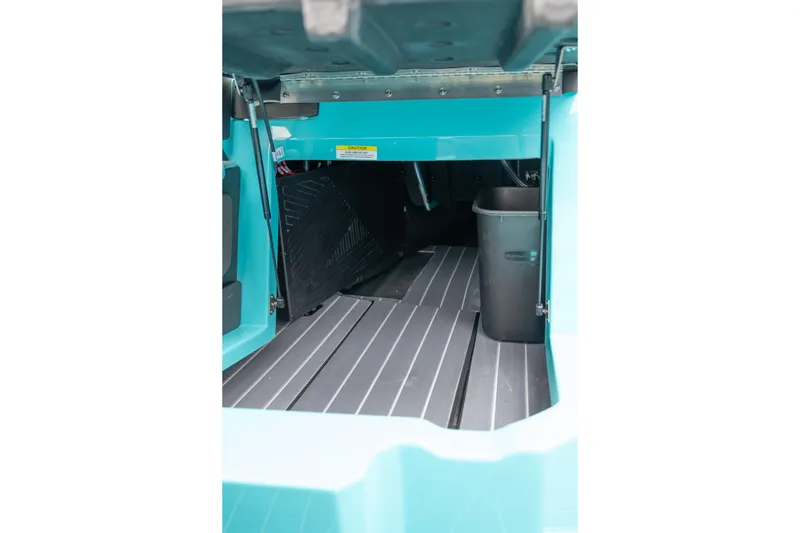 Slide: The Image of Interior view of 2026 MasterCraft X24 boat storage compartment with teal accents. - 41