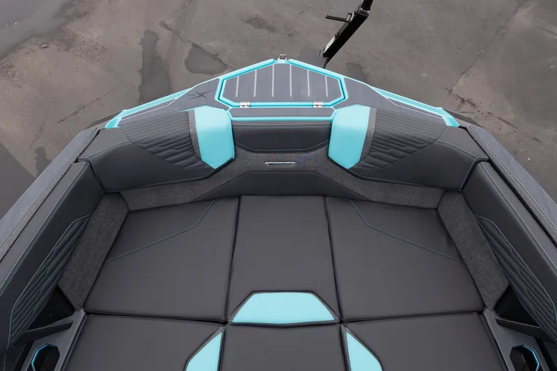 Slide: The Image of 2026 MasterCraft X24 boat interior with sleek black and blue seating design. - 45