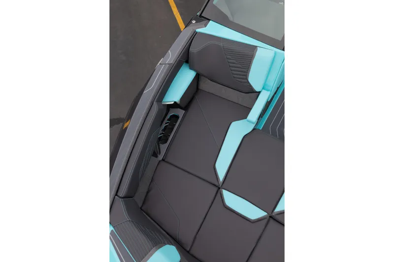 Slide: The Image of 2026 MasterCraft X24 boat interior with sleek black and turquoise seating design. - 49