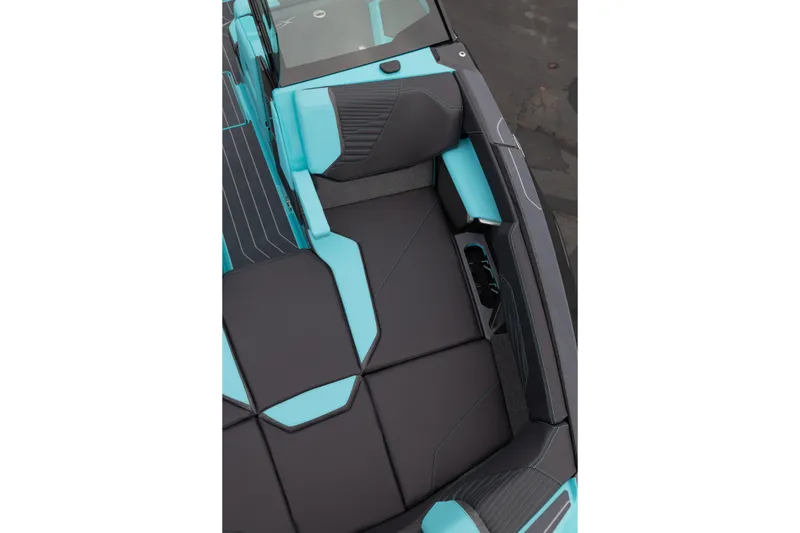 Slide: The Image of 2026 MasterCraft X24 boat interior with sleek black and turquoise seating design. - 50