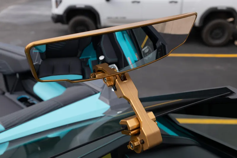 Slide: The Image of 2026 MasterCraft X24 boat with gold rearview mirror and turquoise interior. - 53