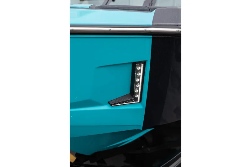 Slide: The Image of 2026 MasterCraft X24 boat detail with sleek turquoise and black design, featuring LED lights. - 66