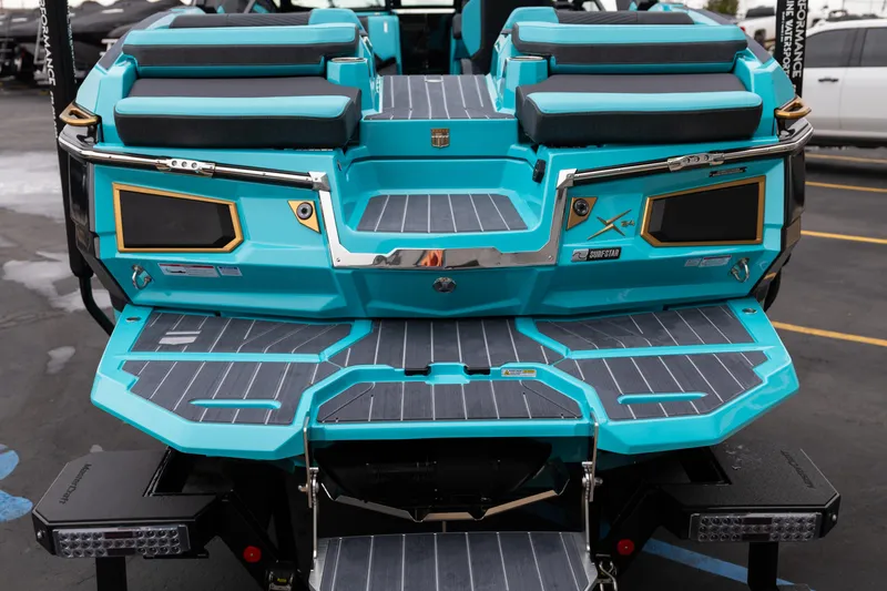 Slide: The Image of 2026 MasterCraft X24 boat with turquoise deck and seating, featuring modern design elements. - 7