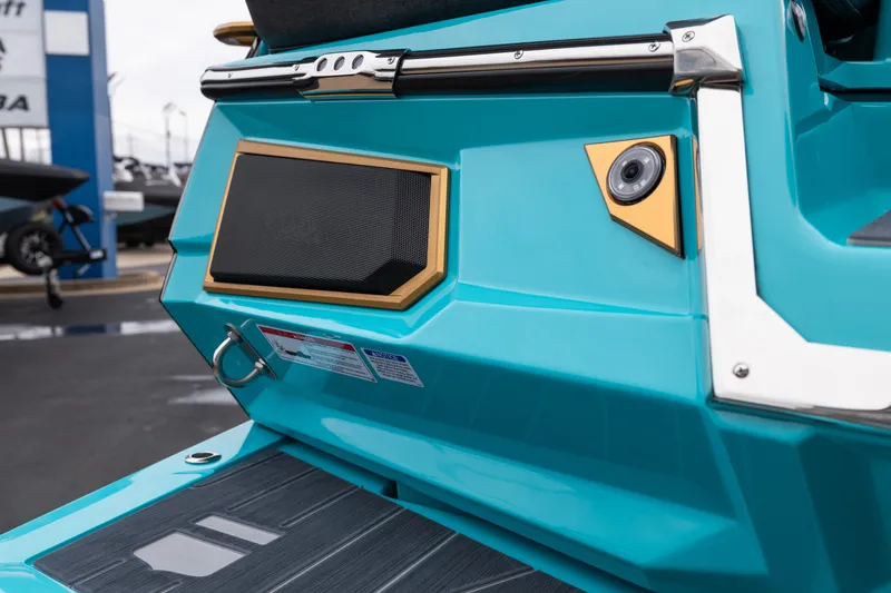 Slide: The Image of 2026 MasterCraft X24 boat with teal exterior, featuring a speaker and camera on the rear. - 9