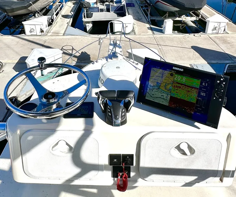 Slide: The Image of Helm of 2003 Grady-White Marlin 300 with navigation equipment and steering wheel. - 13