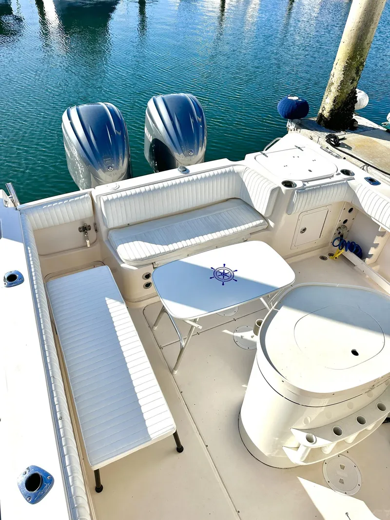 Slide: The Image of 2003 Grady-White Marlin 300 boat interior with seating and twin engines. - 18