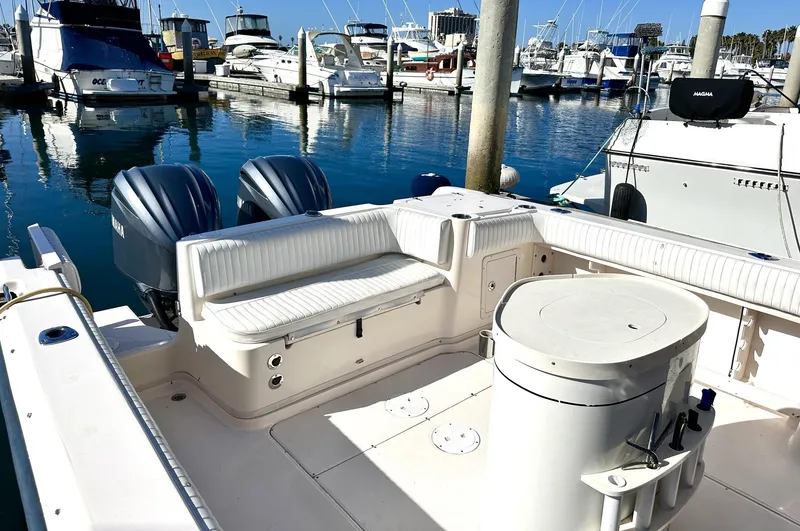 Slide: The Image of 2003 Grady-White Marlin 300 boat docked in a marina with twin engines. - 20