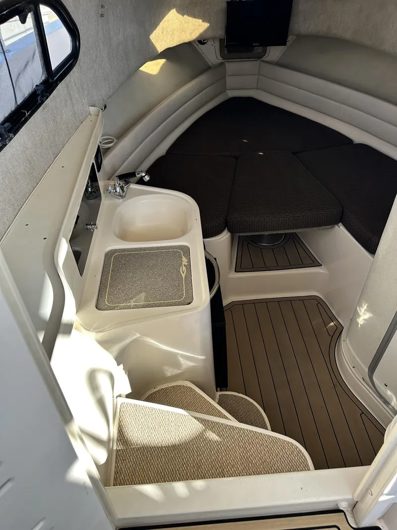 Slide: The Image of 2003 Grady-White Marlin 300 cabin interior with seating and sink. - 25