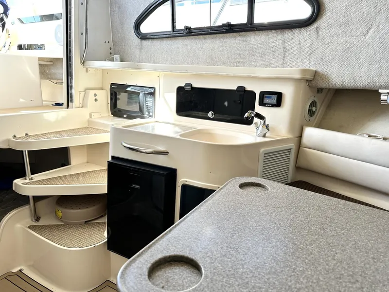 Slide: The Image of 2003 Grady-White Marlin 300 cabin interior with kitchenette and seating area. - 29