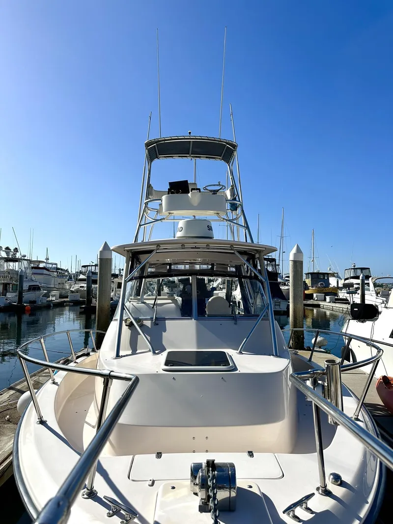 Slide: The Image of 2003 Grady-White Marlin 300 boat docked in a marina under clear blue skies. - 3