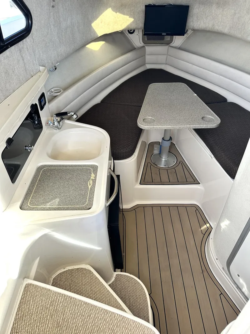 Slide: The Image of 2003 Grady-White Marlin 300 cabin interior with seating, table, and sink. - 30