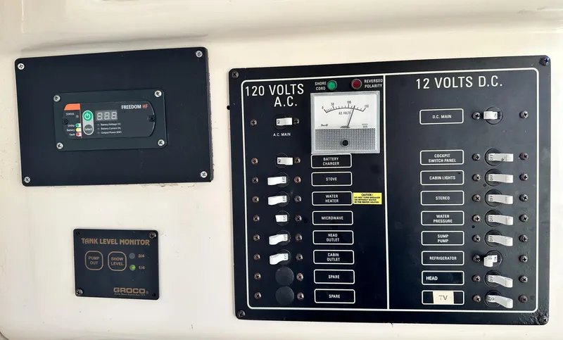 Slide: The Image of Control panel of a 2003 Grady-White Marlin 300 boat, showing electrical systems. - 36