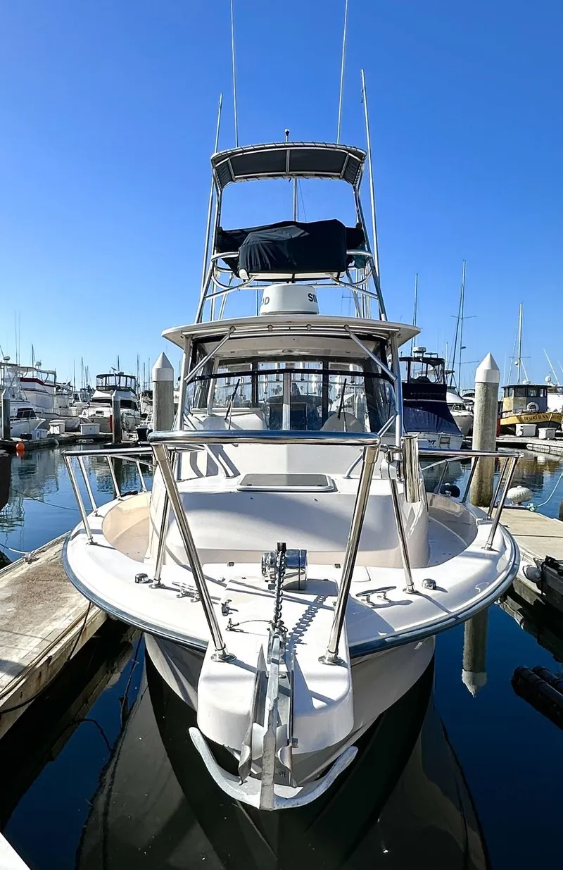 Slide: The Image of 2003 Grady-White Marlin 300 boat docked in marina under clear blue sky. - 4