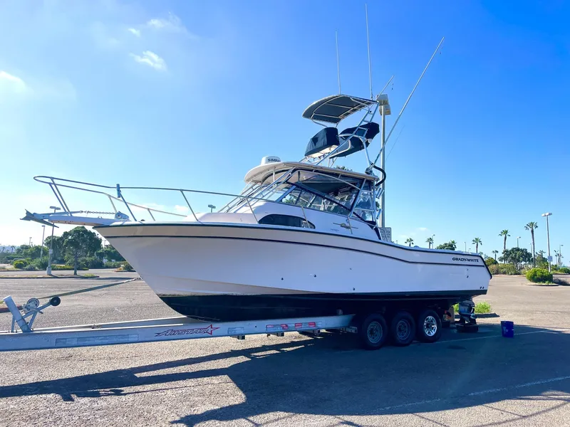 Slide: The Image of 2003 Grady-White Marlin 300 boat on trailer under clear blue sky. - 5