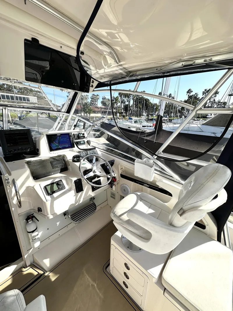 Slide: The Image of 2003 Grady-White Marlin 300 boat cockpit with steering wheel and navigation equipment. - 9