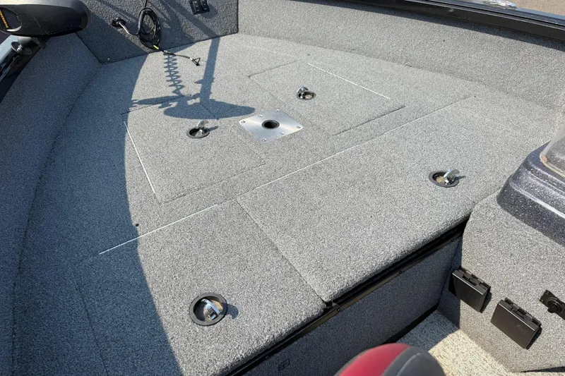 Slide: The Image of 2023 Ranger VS1665SC boat interior with gray carpeted deck and fishing rod holders. - 11