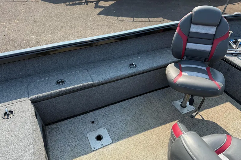 Slide: The Image of 2023 Ranger VS1665SC boat interior with cushioned seating and carpeted flooring. - 14