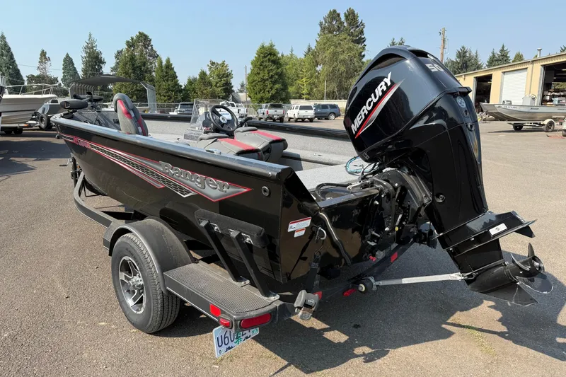 Slide: The Image of 2023 Ranger VS1665SC boat with Mercury outboard motor on a trailer. - 2